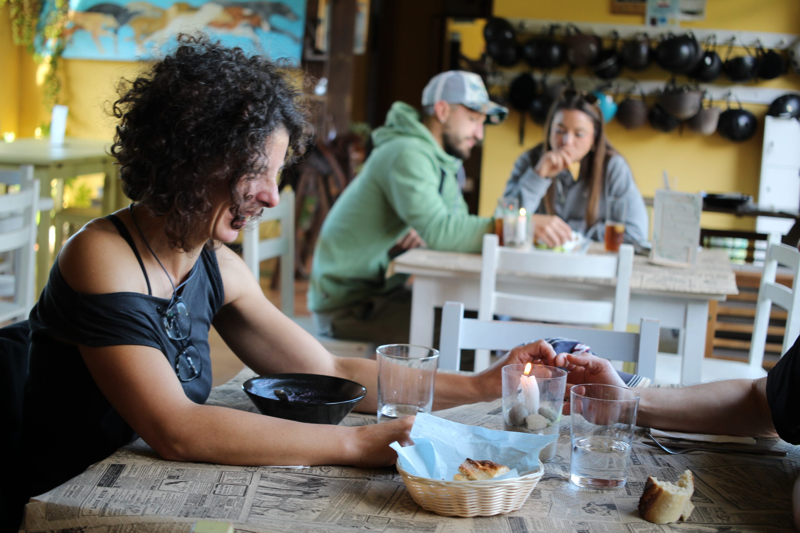 Persona riendo en una mesa y al fondo pareja en otra mesa en el Bar Centauro